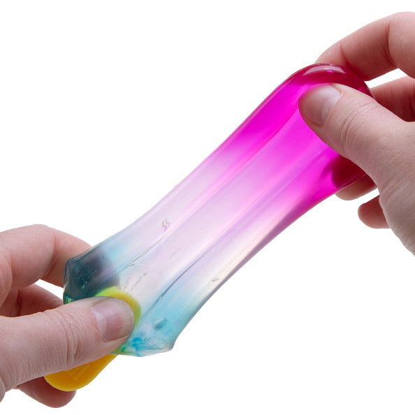 Colorful gradient stress reliever toy being held by a hand on a white background