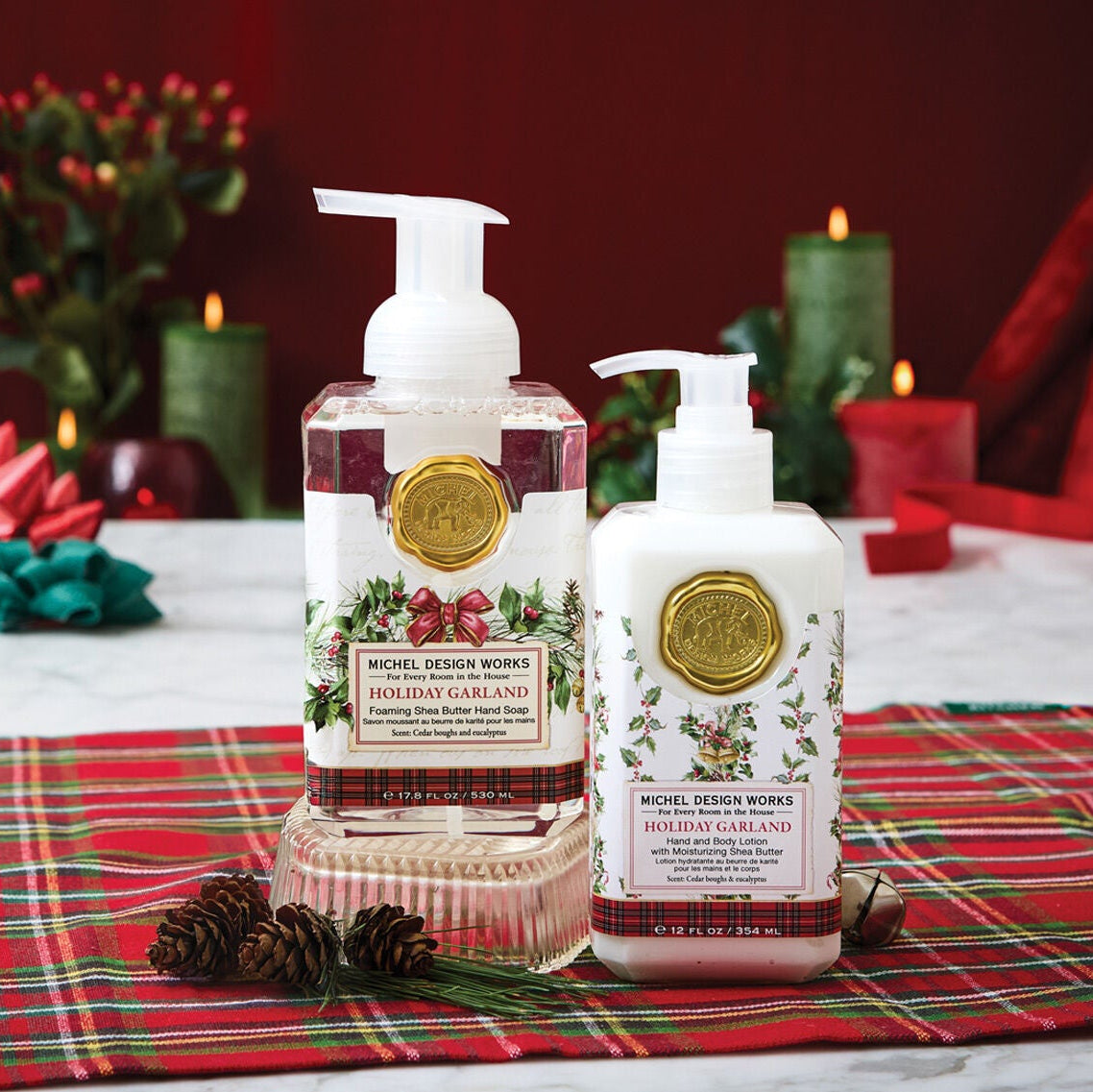Bath and body products on a table with festive decorations and a red background.