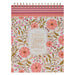 Notebook with floral design and motivational quote on a white background