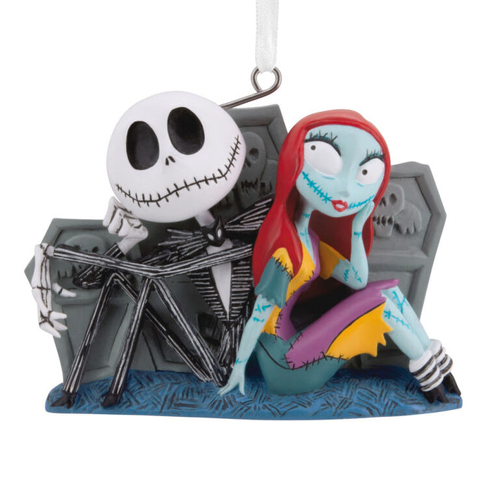 Ornament featuring a skeleton couple sitting together on a white background