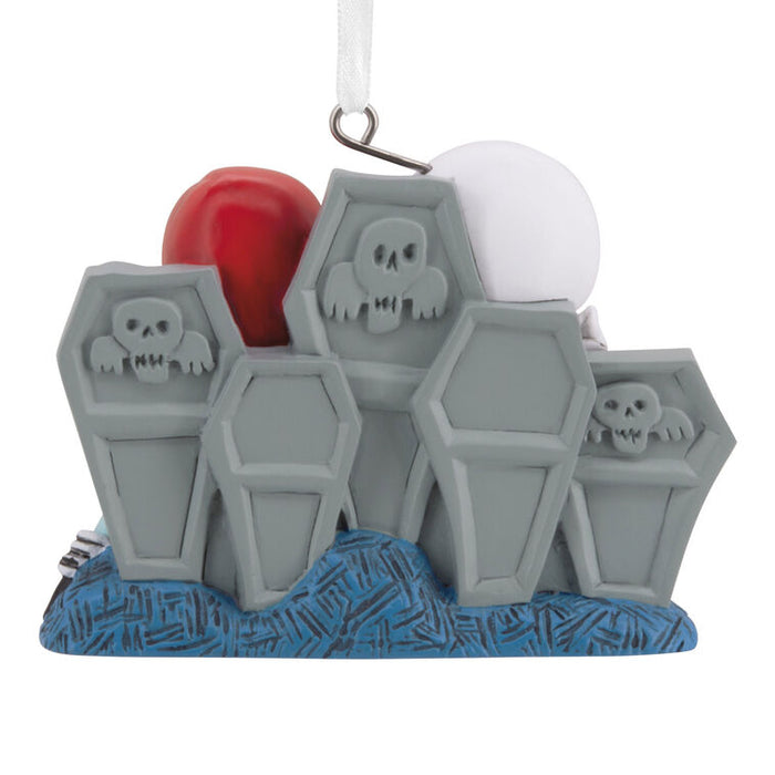 Decorative ornament with coffins, skulls, and a heart on a white background