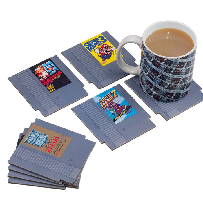 Collection of retro game cartridges and a mug with a game design on a white background