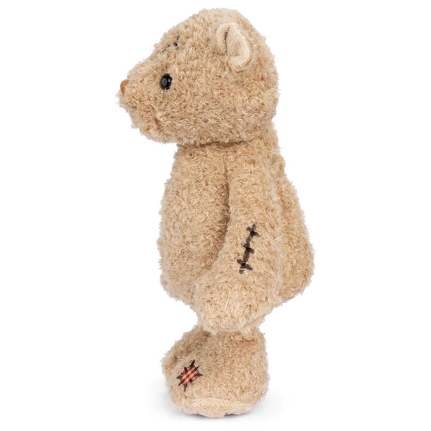 Stuffed teddy bear with visible stitching on a white background