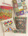 Colorful notebooks with floral designs and motivational text on a wooden surface.
