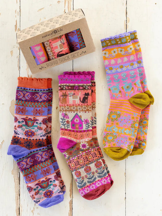 Colorful patterned socks with a box on a wooden surface