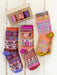 Colorful patterned socks with a box on a wooden surface