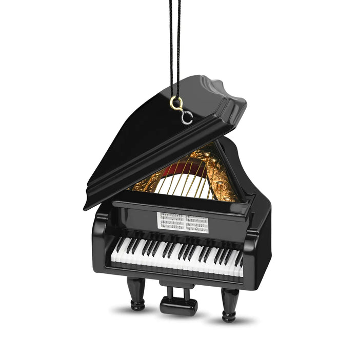 A miniature black grand piano ornament with its lid open, showing gold-colored strings and a black-and-white keyboard, hanging by a black cord with a gold ring and silver hook on a white background.