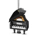 A miniature black grand piano ornament with its lid open, showing gold-colored strings and a black-and-white keyboard, hanging by a black cord with a gold ring and silver hook on a white background.