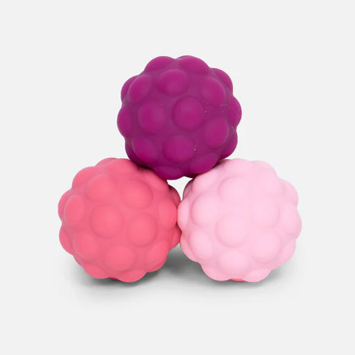 Three pink textured balls on a light gray background