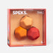 Speks product packaging with three geometric silicone balls in orange, red, and gold on a beige background.