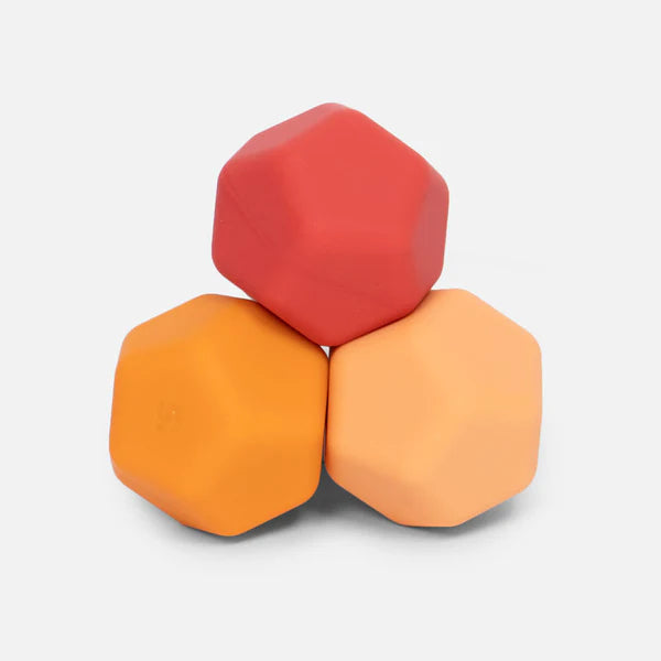 Three hexagonal blocks in red and orange on a light gray background