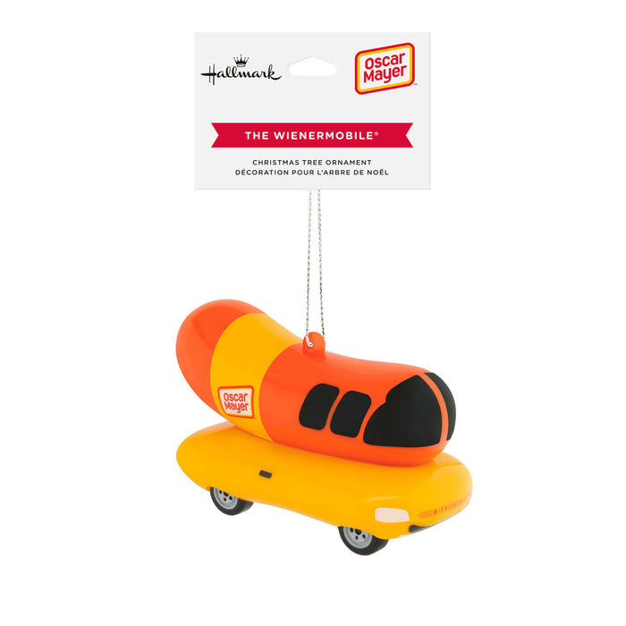 Oscar Meyer The Wienermobile Christmas tree ornament by Hallmark, featuring a hot dog shaped ornament on a yellow car base, shown with its retail header card.