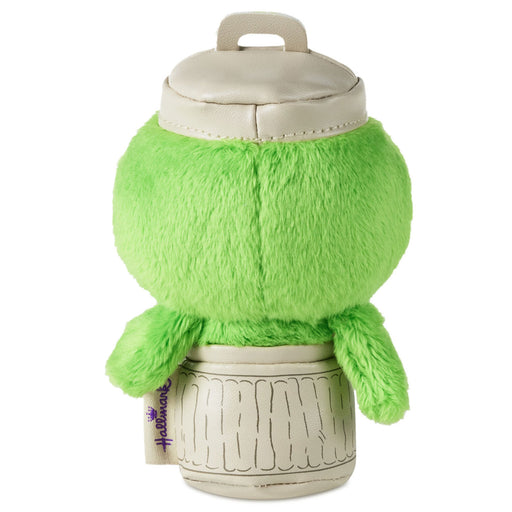 Green plush toy with a white container on a white background