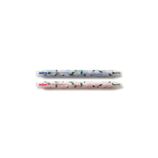 Two floral-patterned pens on a white background