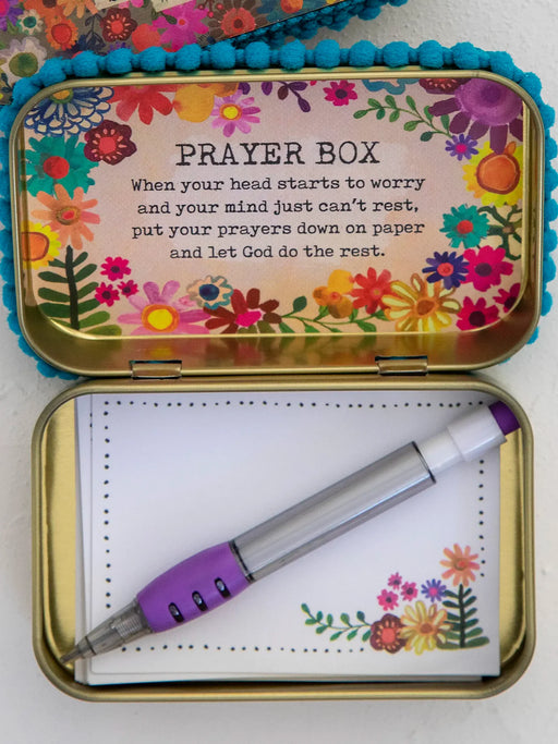 Colorful prayer box with flowers and a pen on a white background