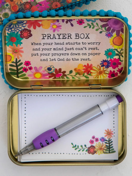 Colorful prayer box with flowers and a pen on a white background