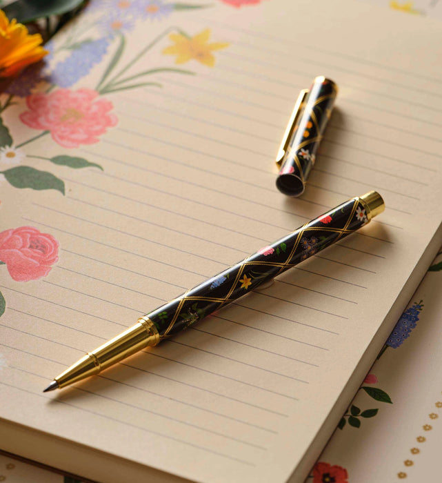 Decorative pen on a floral notebook