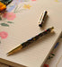 Decorative pen on a floral notebook