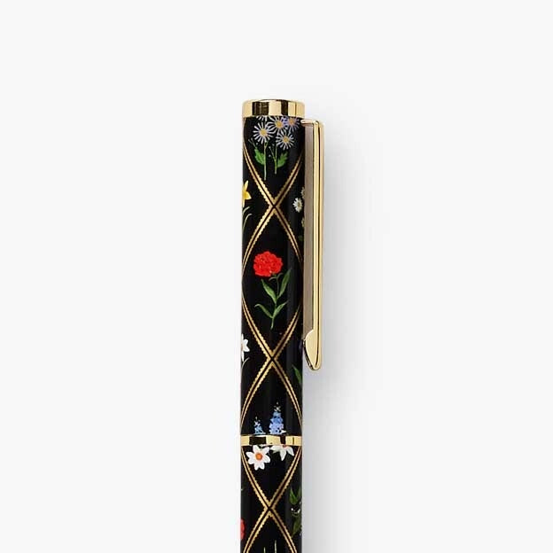 Decorative pen with floral design on a white background