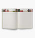 Open notebook with lined pages and decorative top edge on a white background