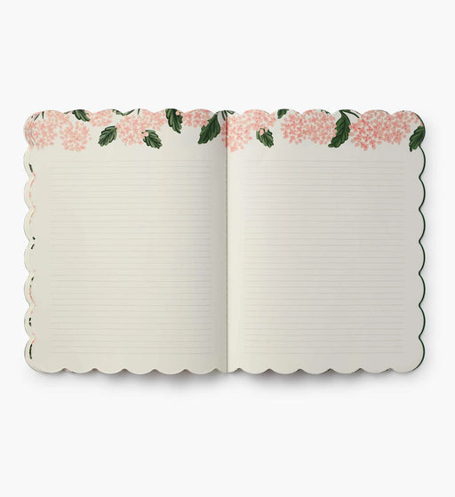Open notebook with floral design on the cover on a white background