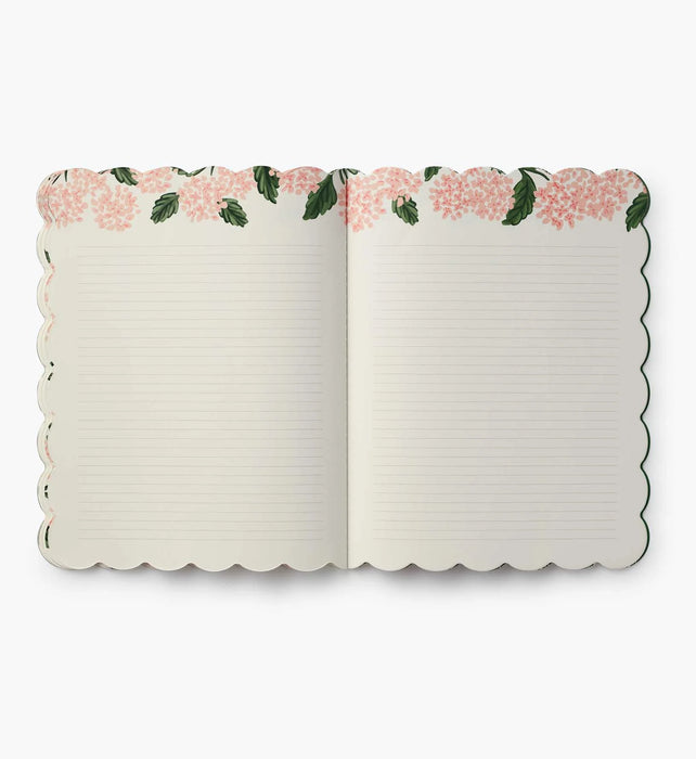 Open notebook with floral design on the cover on a white background