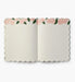 Open notebook with floral design on the cover on a white background