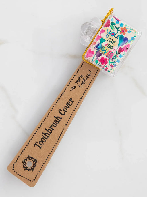 Toothbrush cover with floral design and motivational message on a white background
