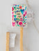 Bamboo toothbrush with a colorful case featuring floral designs and text on a light background.