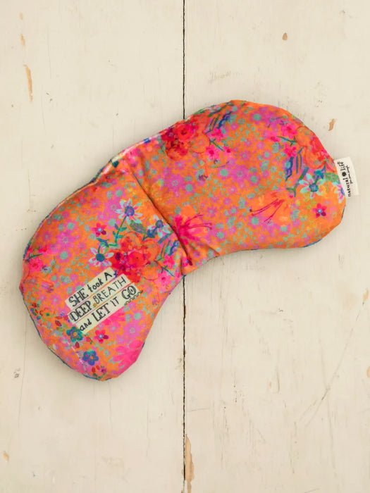 Floral patterned eye mask on a light wooden surface