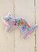 Floral-patterned cat-shaped soft toy on a wooden surface