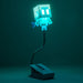 Glowing blue lamp shaped like a pixelated character on a dark green background