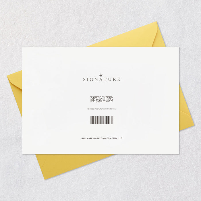 White card with yellow envelope on a textured gray surface