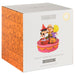 Peanuts Apple Bobbing Figurine packaging box, featuring a white front with character artwork and an orange patterned side panel with cartoon comic strips.