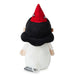A plush toy shown from the back, featuring a white body, a black hat with a red pointed top and small embroidered stars, and pale skin-toned hands and feet. A small fabric tag is attached near the bottom.