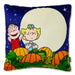 A square decorative pillow featuring a colorful Peanuts Halloween-themed illustration with Charlie Brown, Snoopy, pumpkins, and a full moon on a dark blue starry background.
