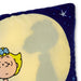 A close-up of a plush throw pillow featuring a dark blue border with white star details and a light cream center, printed with a cartoon character and a large cast shadow on the front.