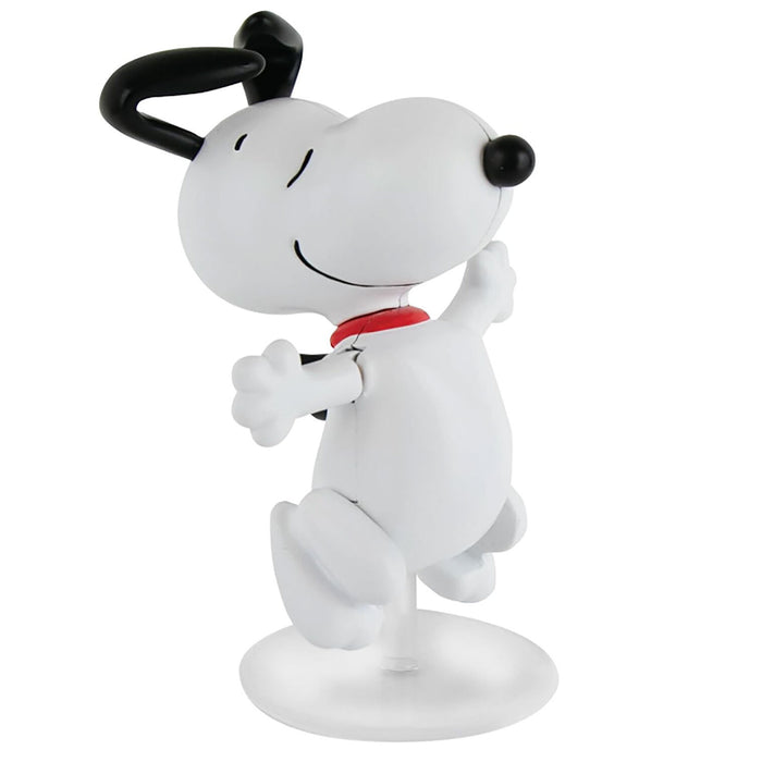 A white Snoopy figurine wearing a red collar and black bow tie, posed dancing on a clear circular base against a white background.