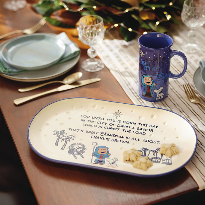 Decorative plate with Christmas-themed design and text on a table setting.