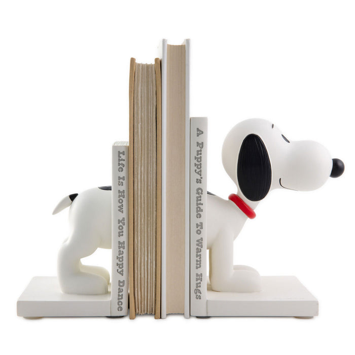Snoopy dog bookends holding books on a white background