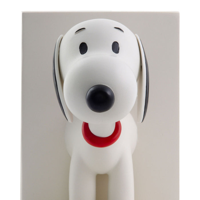 Dog-shaped doormat with a red collar on a light gray background