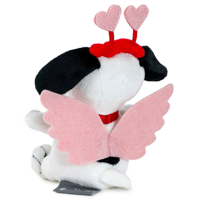 Plush toy resembling a dog with black fur, white chest, pink wings, and heart-shaped antennae on a white background