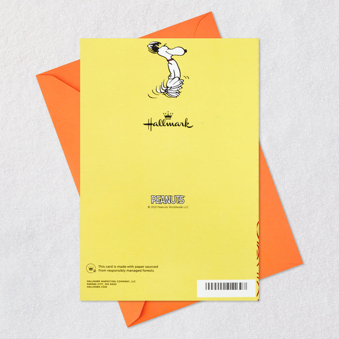 Yellow greeting card with Snoopy illustration and Hallmark logo, featuring an orange envelope on a light gray background.
