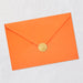 Orange envelope with a gold seal on a light gray background