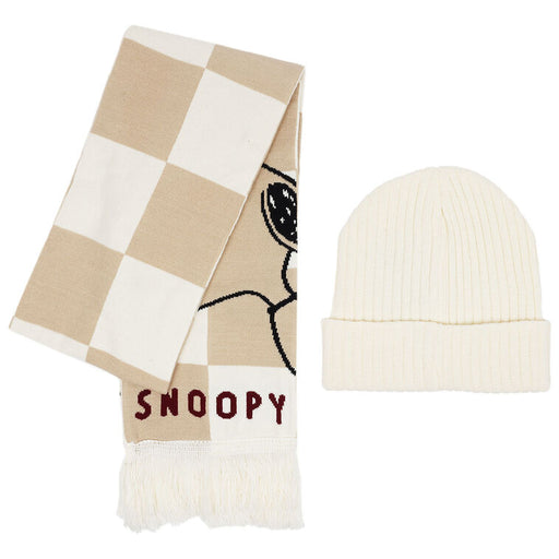 Checkered scarf with Snoopy design and white beanie on a white background