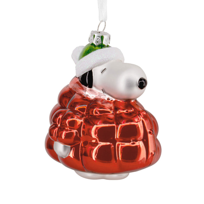 Christmas ornament of a dog in a red coat with a white hat on a white background