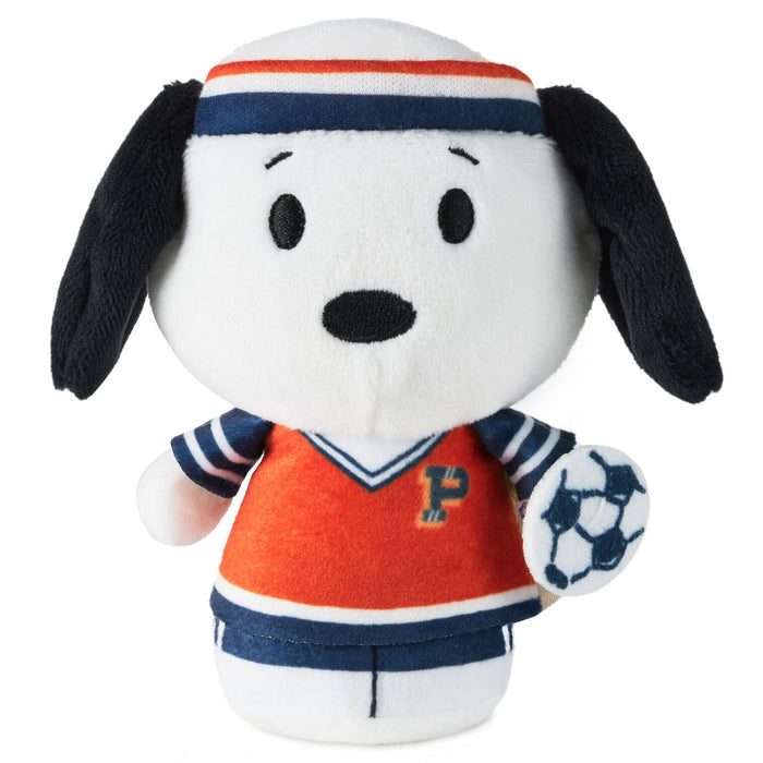 Plush toy resembling a dog in sports attire with a soccer ball on a white background