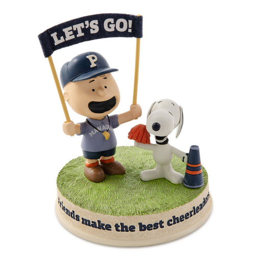 Figurine of a boy and dog with 'Let's Go!' sign and 'Friends make the best cheerleaders' text