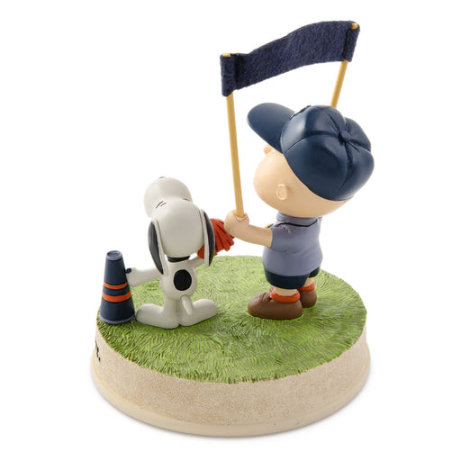 Figurine of a character playing golf with a dog on a grassy base