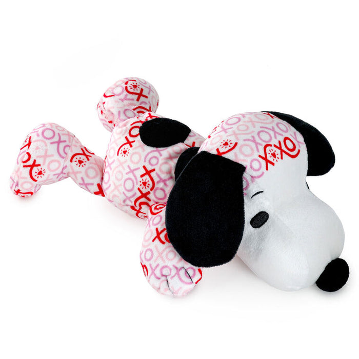Plush toy resembling a dog with a pink bandana featuring red heart and cross patterns on a white background